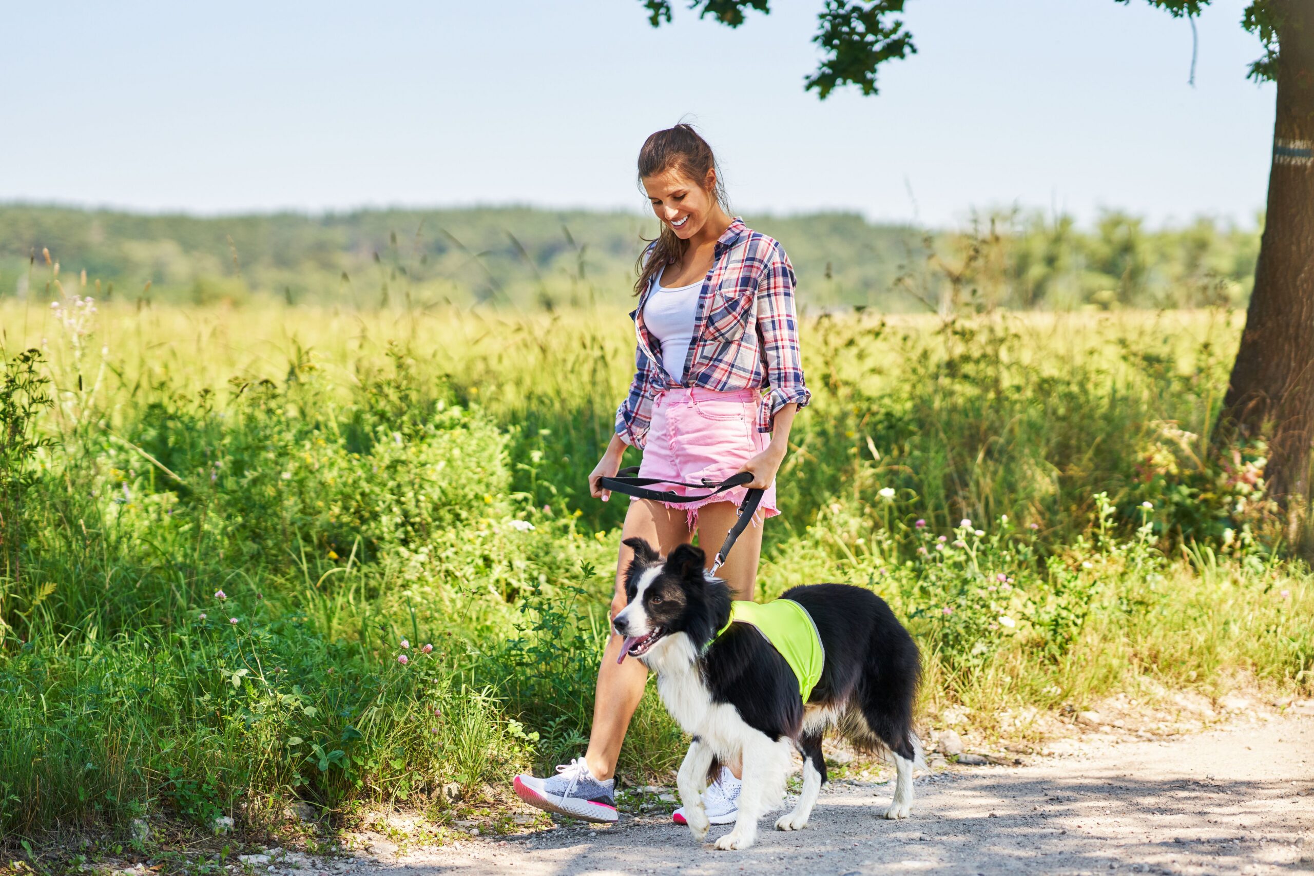Woman walking her dog outdoors, representing well-being and everyday life.