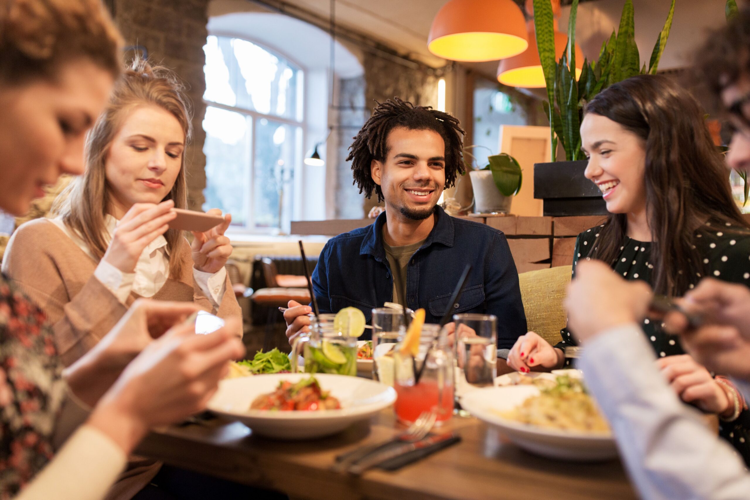 Group of friends sharing a meal together in a relaxed social setting.